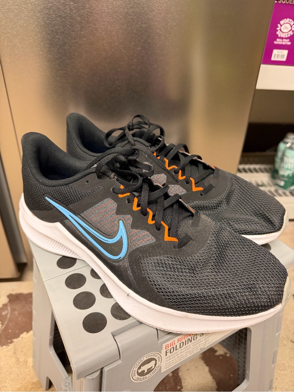 Nike Men’s Black Athletic Shoes with Light Blue Swoosh and Orange Accents